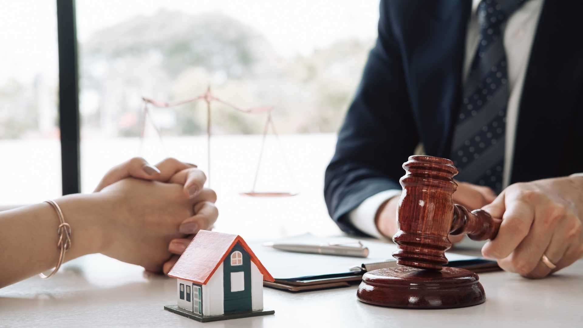 a gavel a house figurine